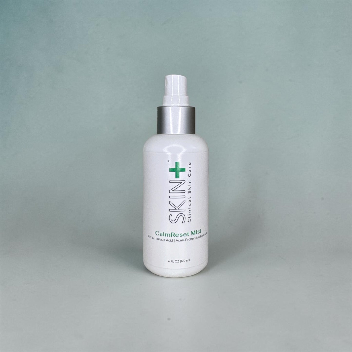 White bottle with a silver cap on a gray background