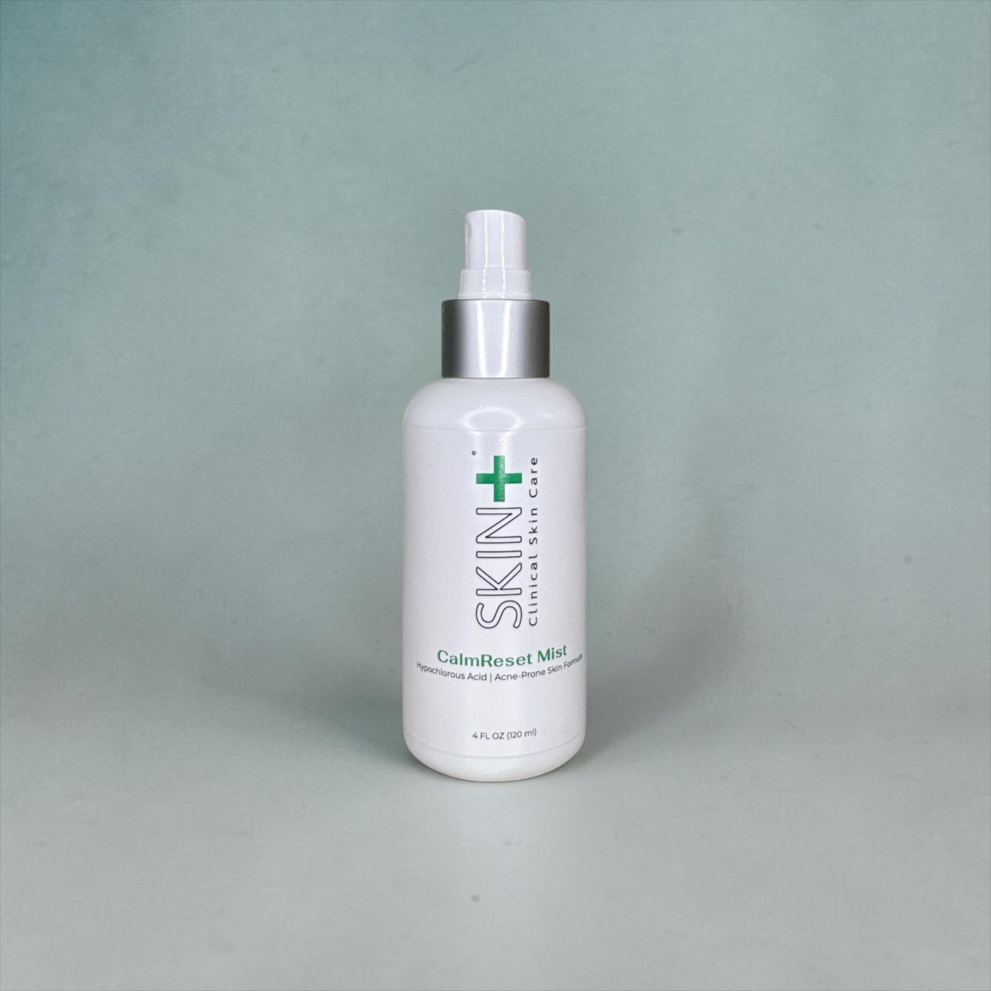 White bottle with a silver cap on a gray background