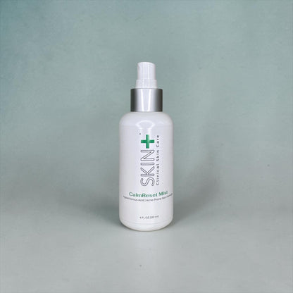 White bottle with a silver cap on a gray background